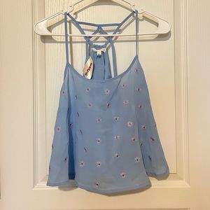 Flowy blue blouse with small embroidered red flowers. Size L